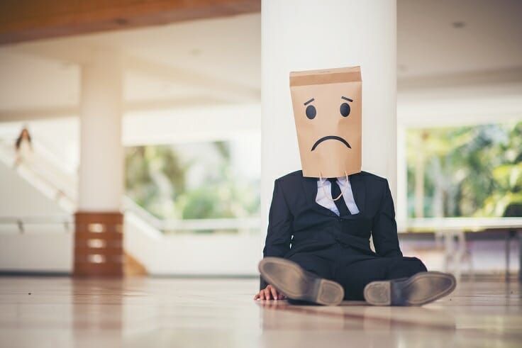 Young business man crying abandoned lost in depression sitting, emotion face